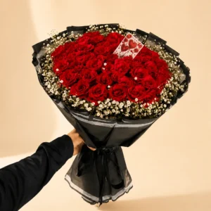 Heart-shaped red rose bouquet with white filler flowers
