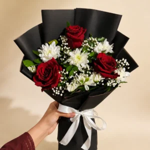 Red rose and white daisy bouquet with green foliage