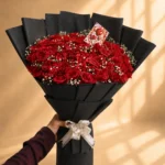 Luxury red rose bouquet with baby's breath in black wrapping
