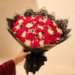 Red rose and white daisy bouquet in black wrapping