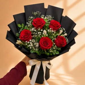 Five red rose bouquet with baby's breath in black wrapping